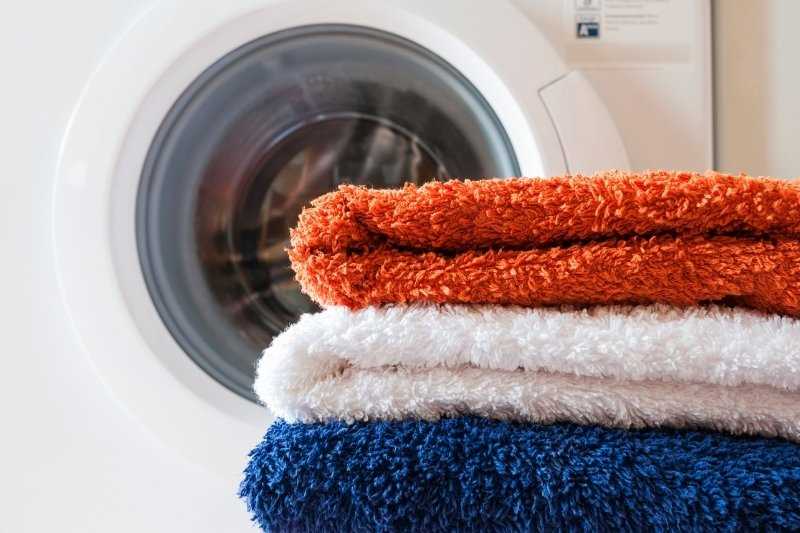 Why should you wash new towels before use?